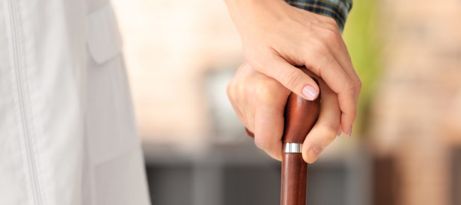 man with cane has multiple sclerosis