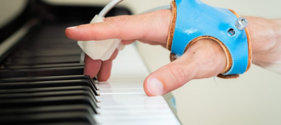 piano & hand of person with dystonia